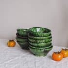 a stack of many green tamegroute bowls sourced from morocco