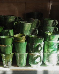 stacked green tamegroute cups in sunlight