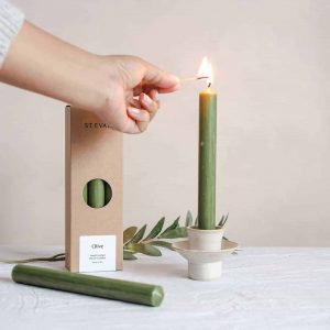 lighting a st eval olive green dinner candle we are nomads