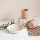a grouping of handmade ceramics two cups and a small side plate we are nomads
