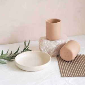 a grouping of handmade ceramics two cups and a small side plate we are nomads