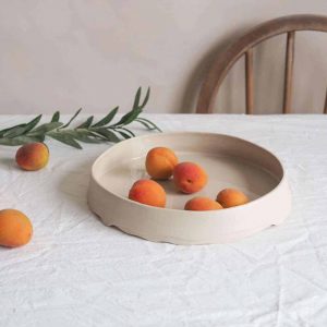 beige ceramic fruit bowl with wave bade detail we are nomads