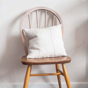 hand sewn french striped fabric cushion on ercol inspired wooden chair