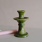 a handmade textured green tamegroute candlestick with a pink st eval candle