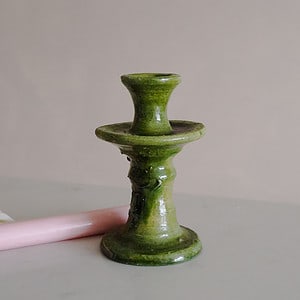 a handmade textured green tamegroute candlestick with a pink st eval candle
