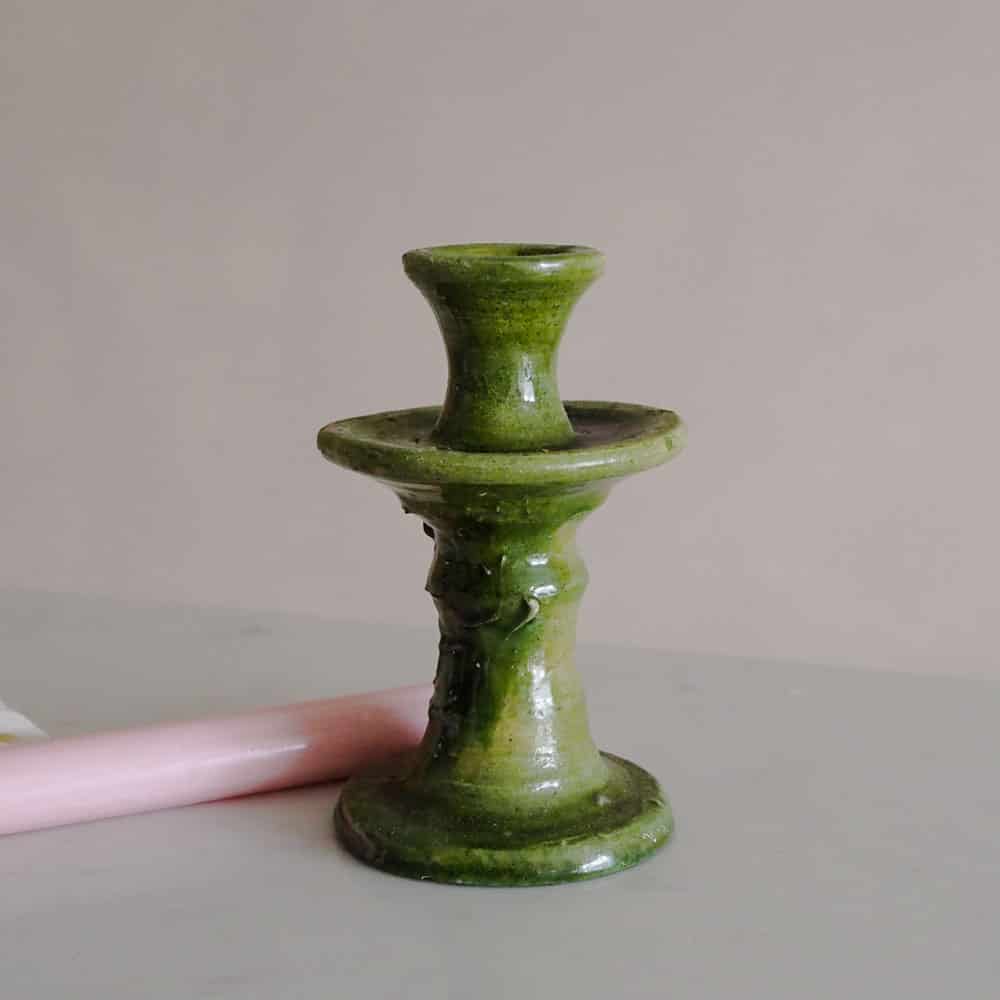 a handmade textured green tamegroute candlestick with a pink st eval candle