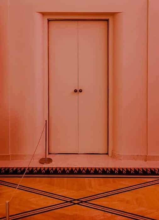 1930s art deco pink door at villa serralves in porto we are nomads