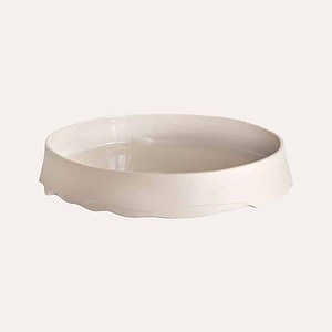 Cream fruit bowl with uneven each rim. Made in London. The inside is matte and the inside gloss
