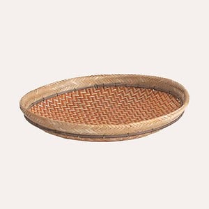 Natural woven basket with woven orange colour pattern. Can be used for fruit or hung on the wall