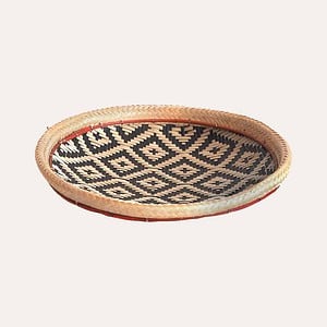 Natural woven basket with black square pattern woven into the basket