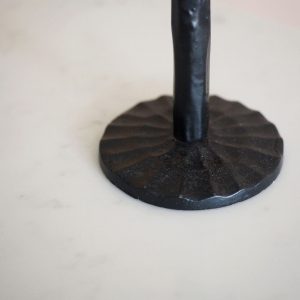 wave base detail of a black iron candlestick on a marble base we are nomads, made by st eval cornwall