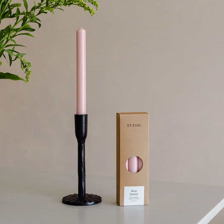 Black iron candle stick. A long stem to hold candles at the top with a pack of 6 pink dinner candles