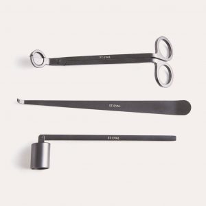 a set of black iron accessories for a candle, trim your candle wick and extinguish candles with this kit