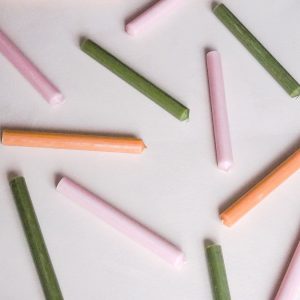 a collection of st eval coloured organic dinner candles in green pink and orange